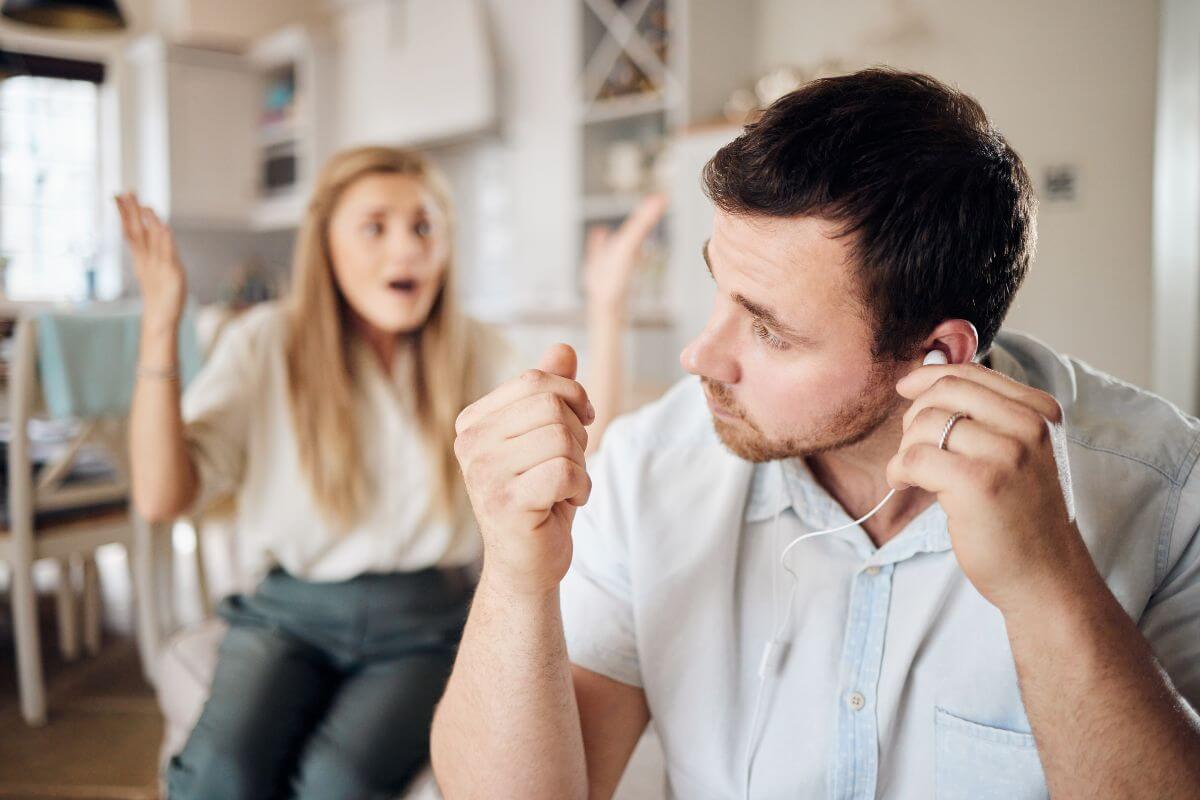 The picture tells about a girl complaining and a man using an earphone which means avoids discussing long-term financial plans may not be financially prepared, a secure future requires planning together.