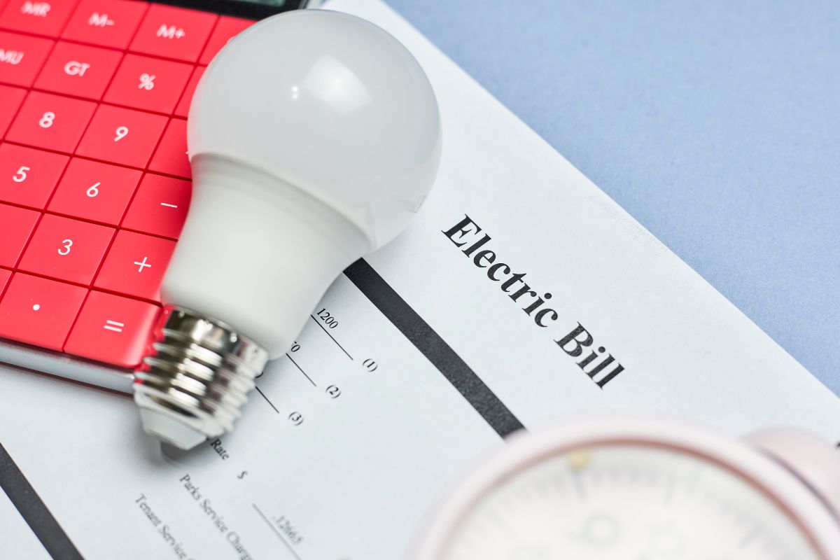 The picture shows a bulb and paper with electric bill paper.