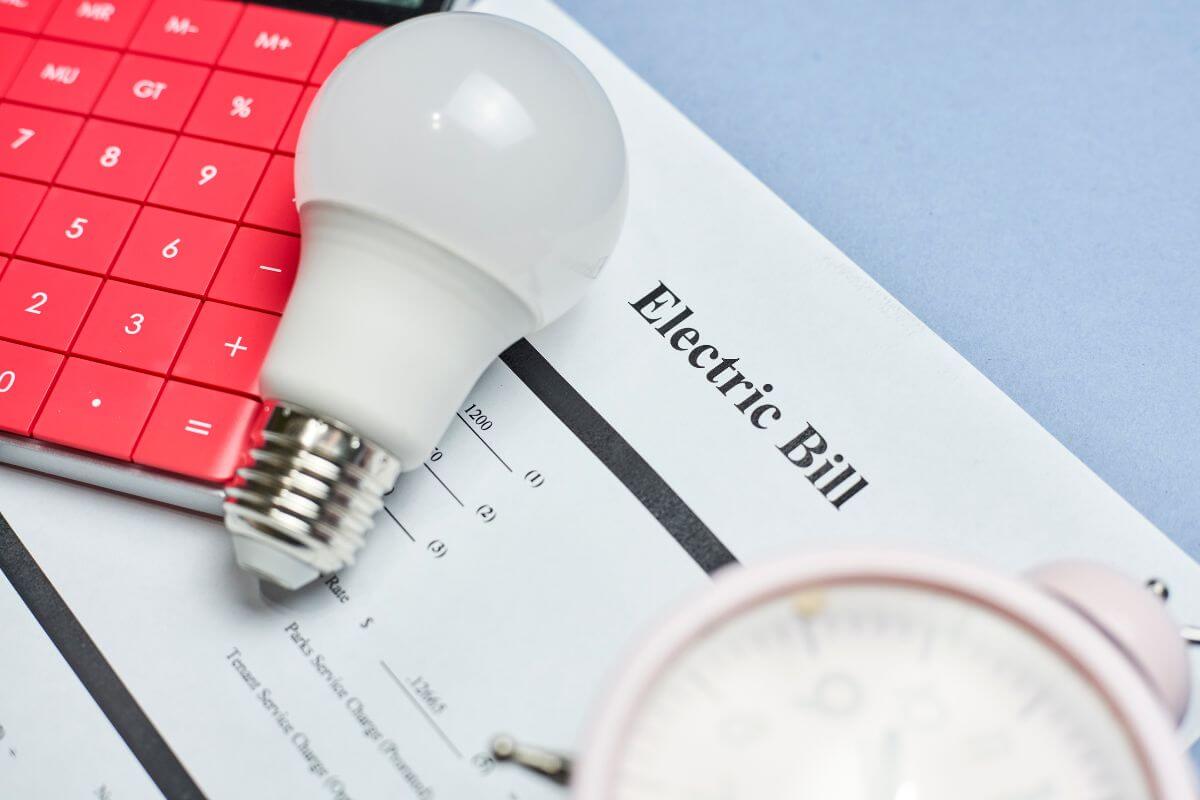 The picture tells about a calculator, a bulb, a clock, and a piece of paper with notes indicating that disregarding financial responsibilities can lead to serious problems.