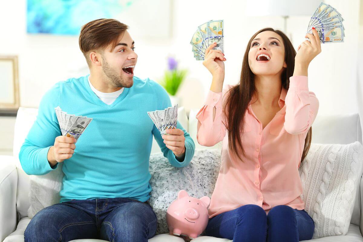 The photo shows a couple holding dollar bills and cheering referring to views money as a tool for control in the relationship can create an unhealthy power dynamic.