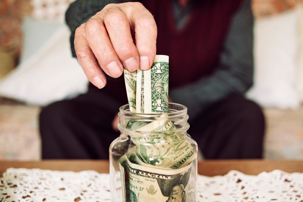 Image of a senior man saving money.