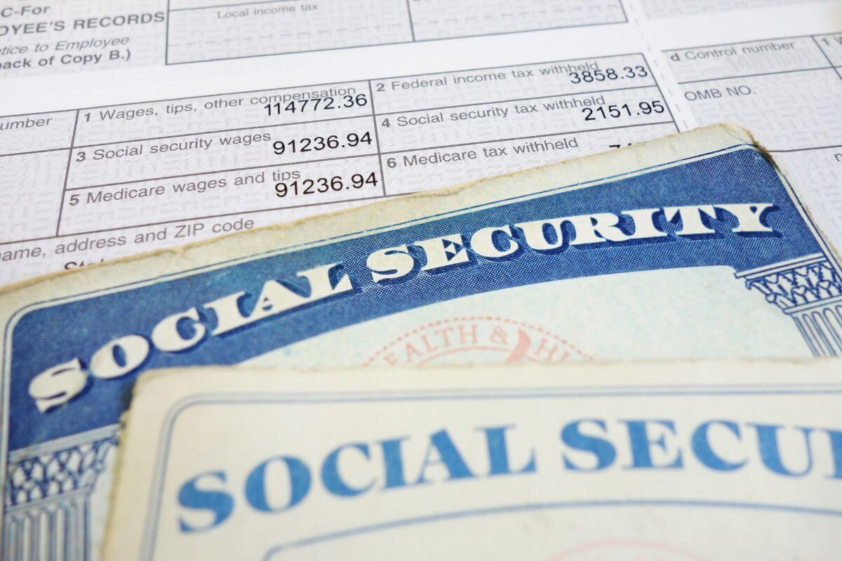 The picture shows a form with notes and papers indicating that reviewing their income sources is a good first step to staying updated and accurate.