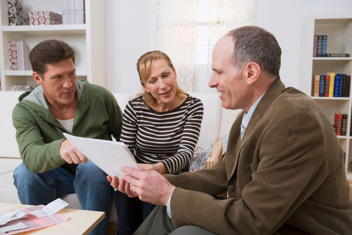 The image tells about a man in the suit explaining the papers to the couple which means a financial planner can help asses their retirement readiness and become financially prepared and organized in the future.