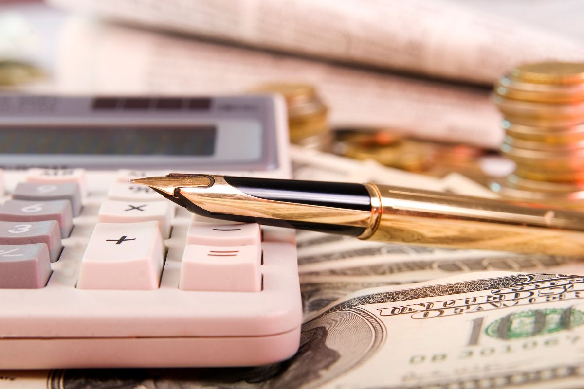 The photo shows a calculator and money.