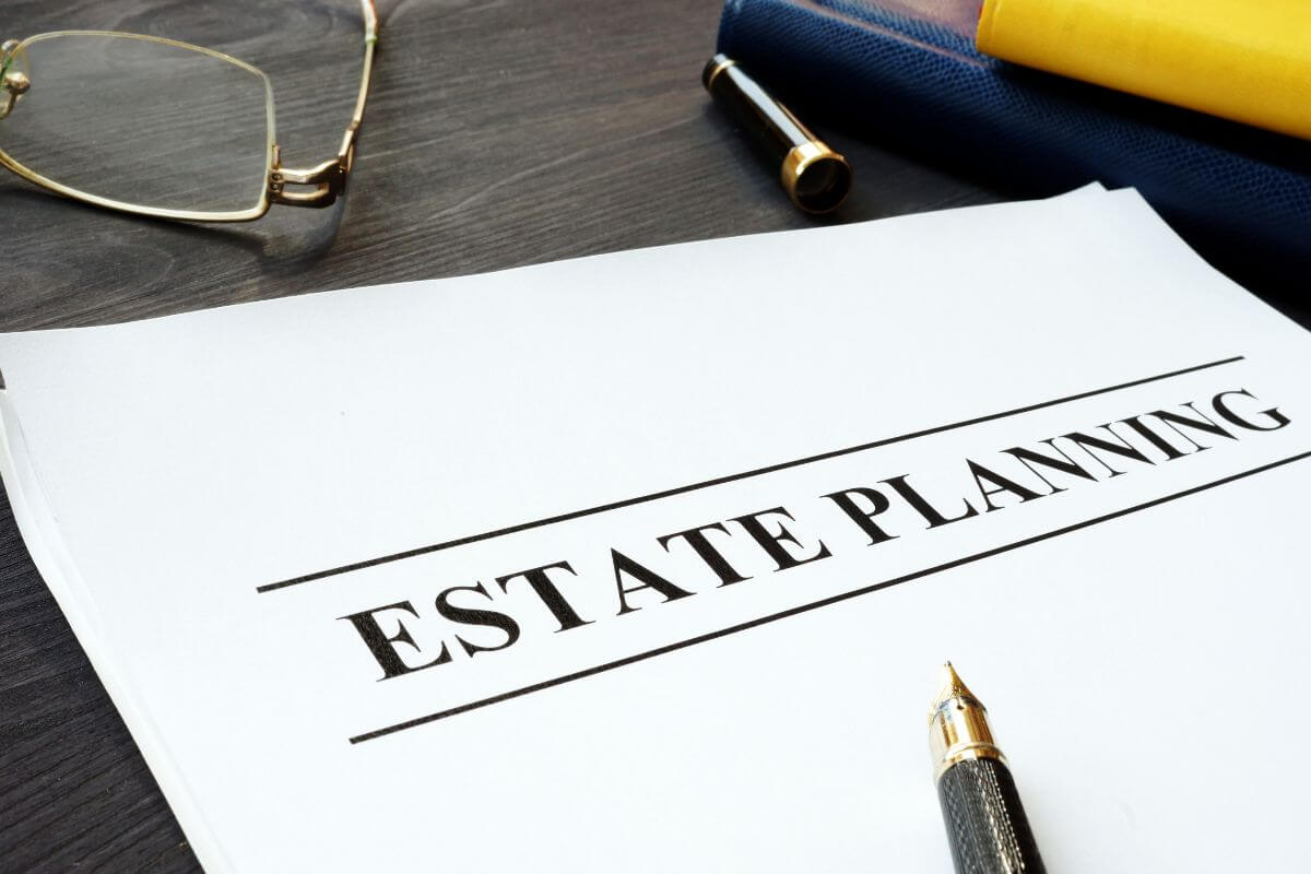 The picture tells about an eyeglass, a notebook, a pen, and a piece of paper with notes indicating to double check their estate planning is handled to make sure no trouble in the future will lead to stress.