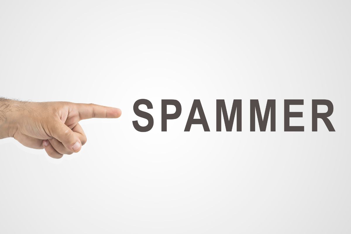 Picture of a man's hand pointing to spammer wording.