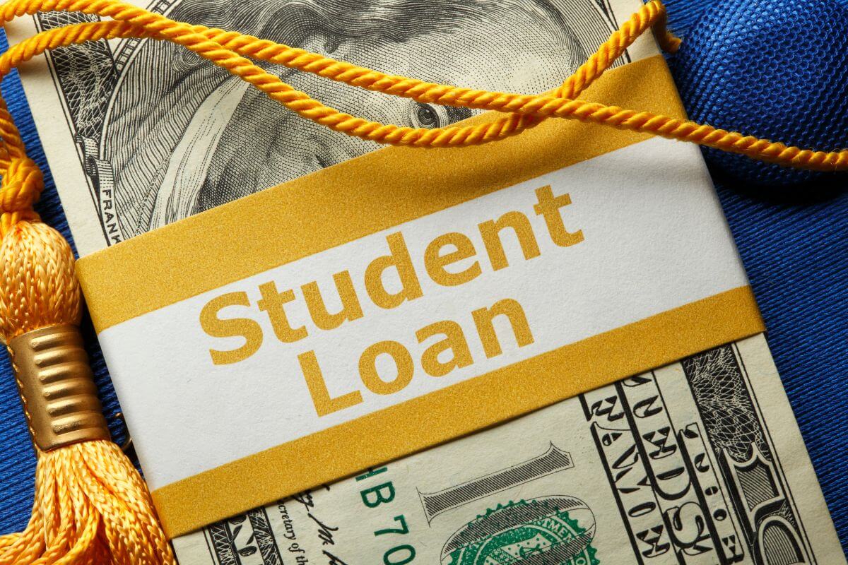 The picture shows a tassel and a buck of dollar bills which means a student loan can be a heavy burden, pay them off before retirement so they don't cut into your savings.