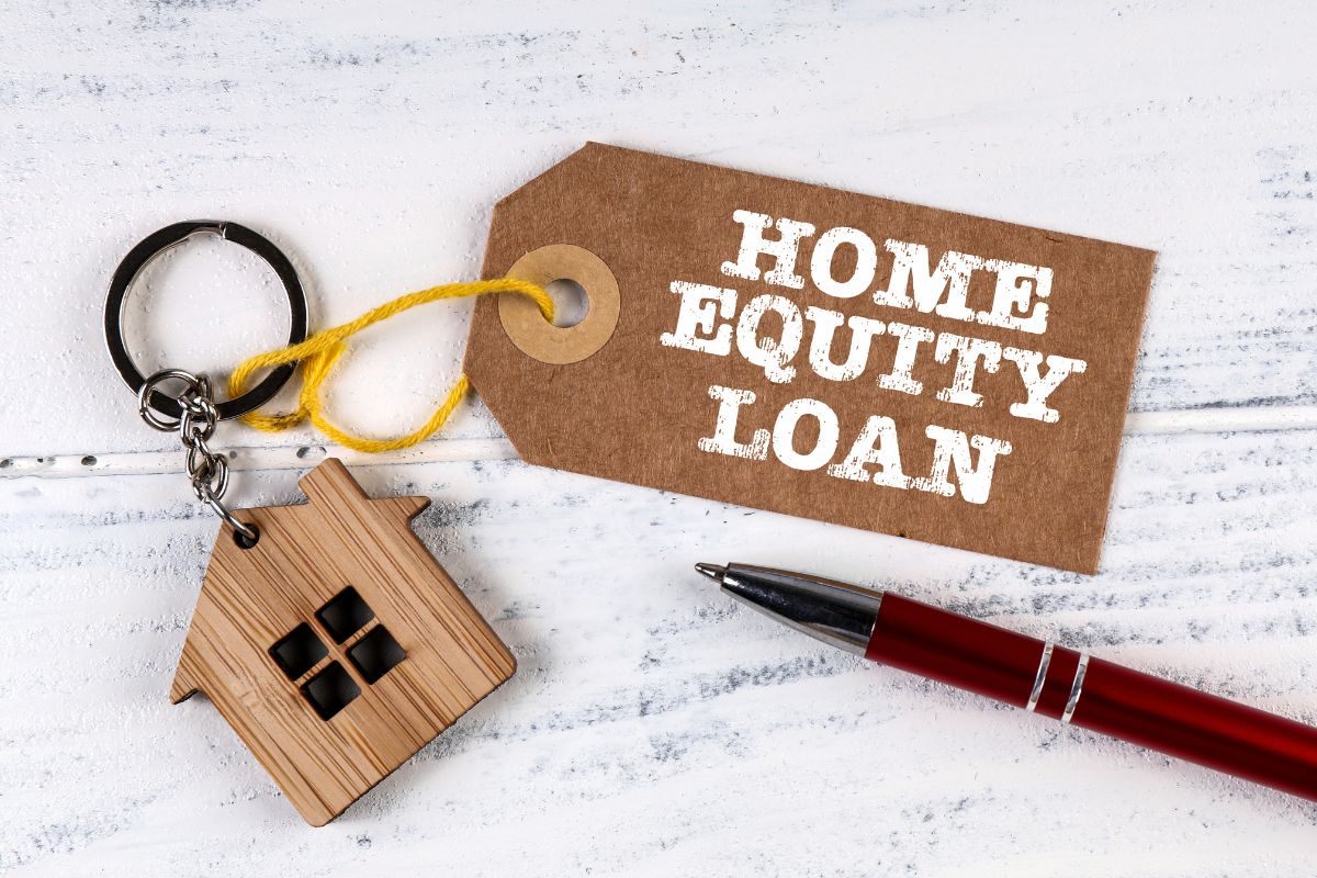 Photo of a pen and keychain with home equity loan wording.