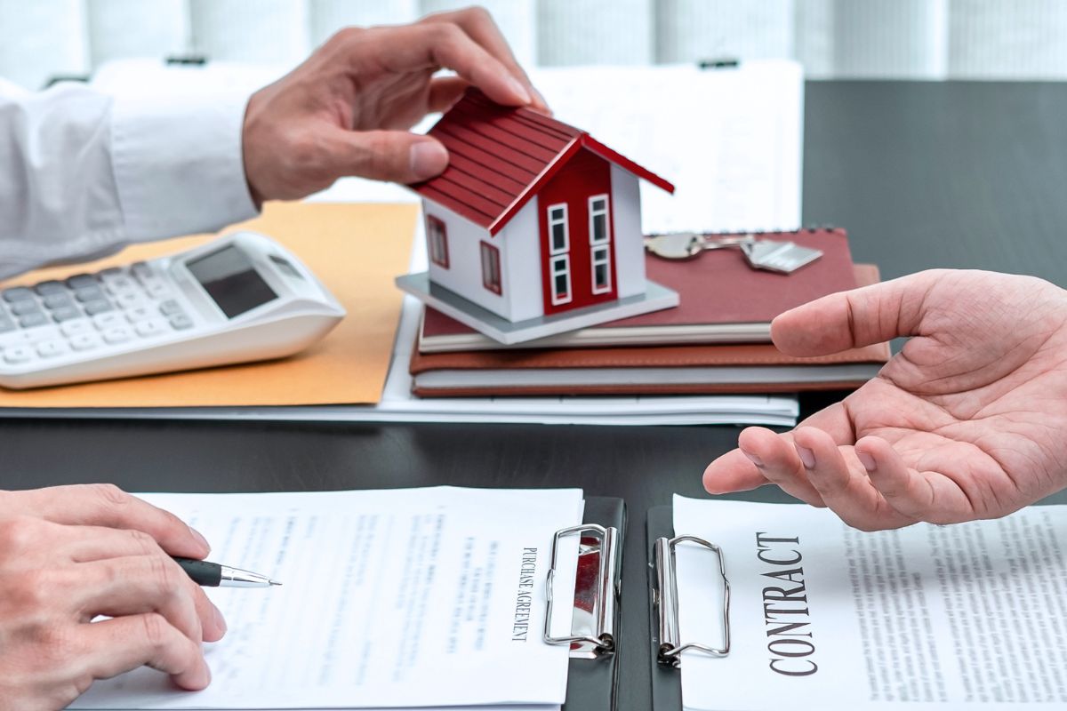 The picture shows men signing a loan contract.