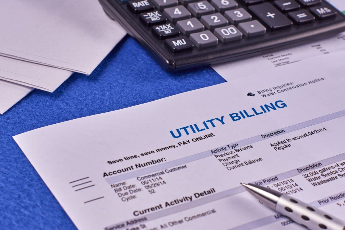 The image shows a calculator, a pen, and papers with notes referring to the unpaid utility can damage your credit and lead to legal trouble, clearing these debts before retirement keeps your finances clean.