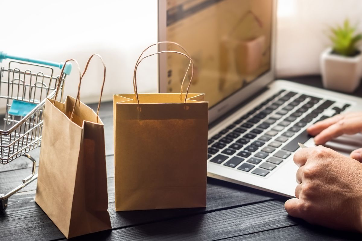 Image of a man's hand shopping online.