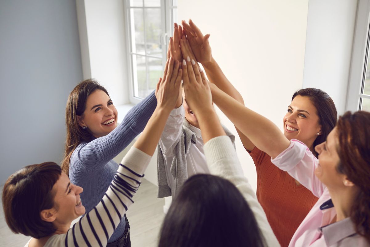 Image of women joining a group.