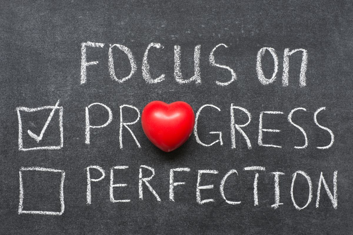 The image shows a board with a focus on progress wording.