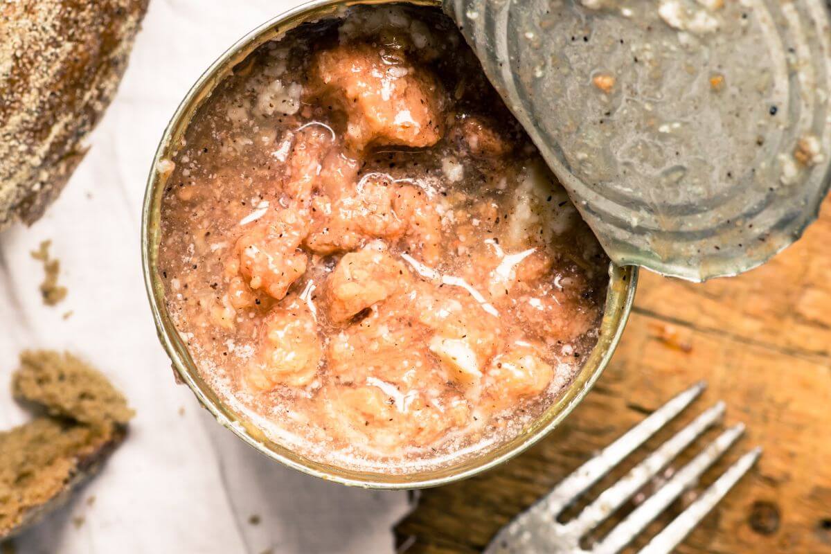 The image shows a fork and canned beef stews that are great for those who need fast and inexpensive food options.