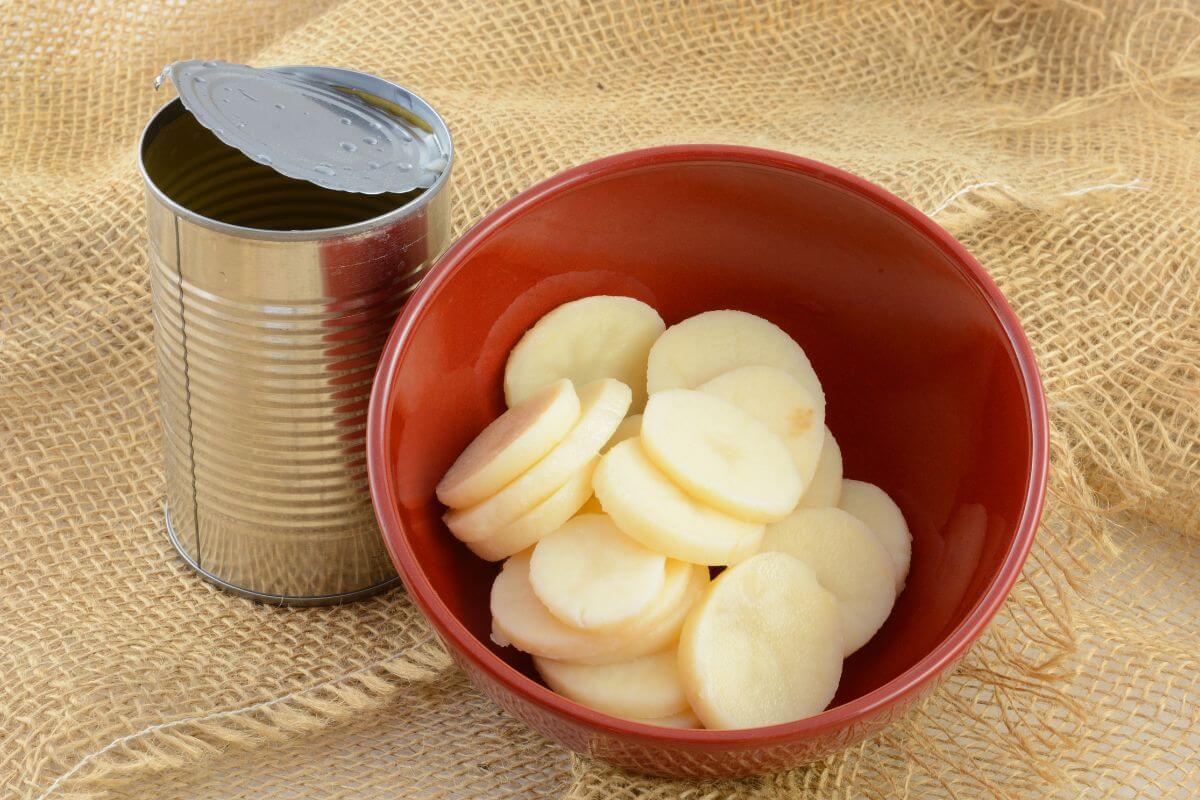 The image shows a can and a bowl of sliced potatoes referring to canned potatoes are a great shortcut for quick side dishes and a smart option for easy budget-friendly cooking.