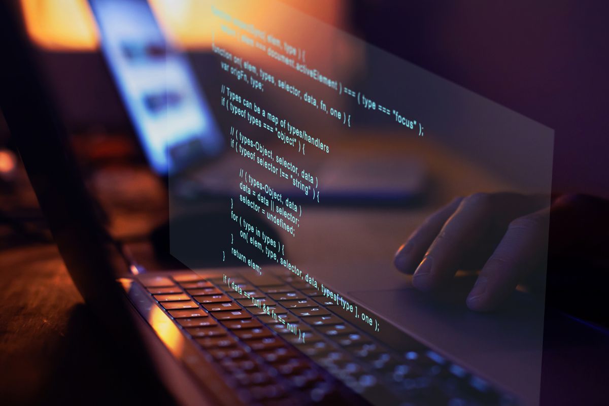 Photo of a man's hand working on a software development.