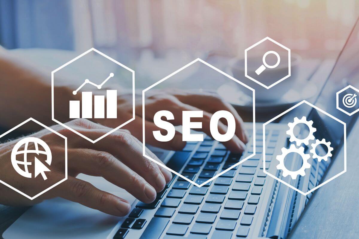The picture of a man's hand using a laptop with a screen display which means an SEO specialist can be a great way to make money online with a flexible time. 