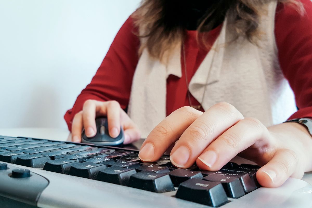 The picture shows a woman working on data entry.