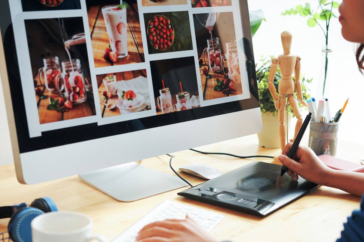 The image shows a girl editing the images on the screen to sell stock photos can be a passive way to earn when people download them.