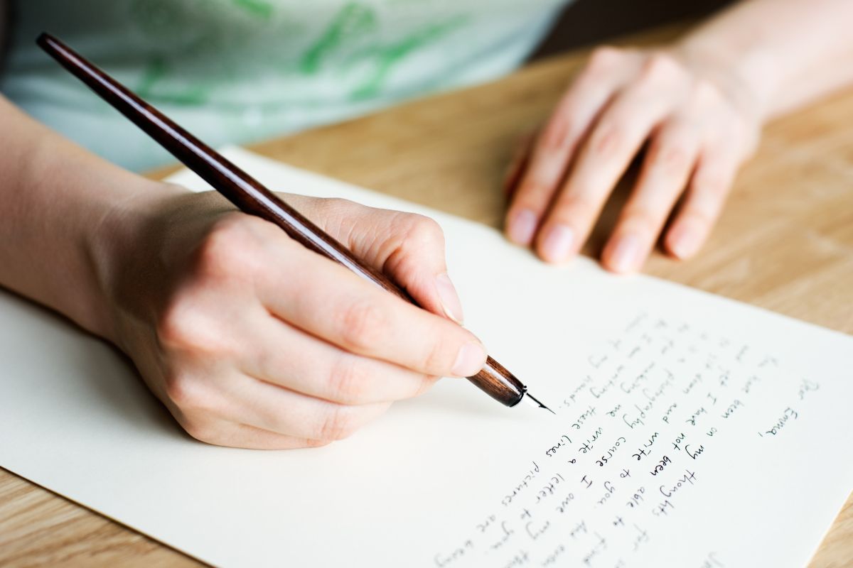 Image of a woman writing a heartfelt letter.