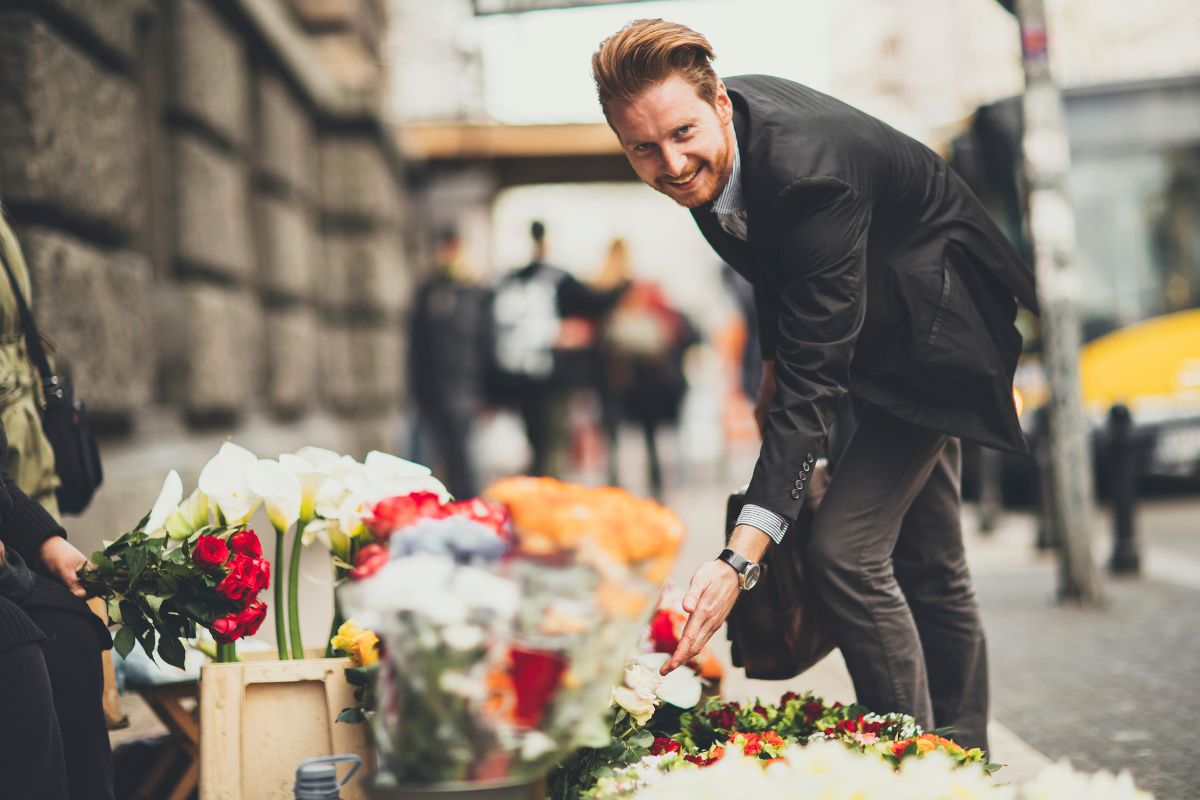 Image of a man buying a flower.