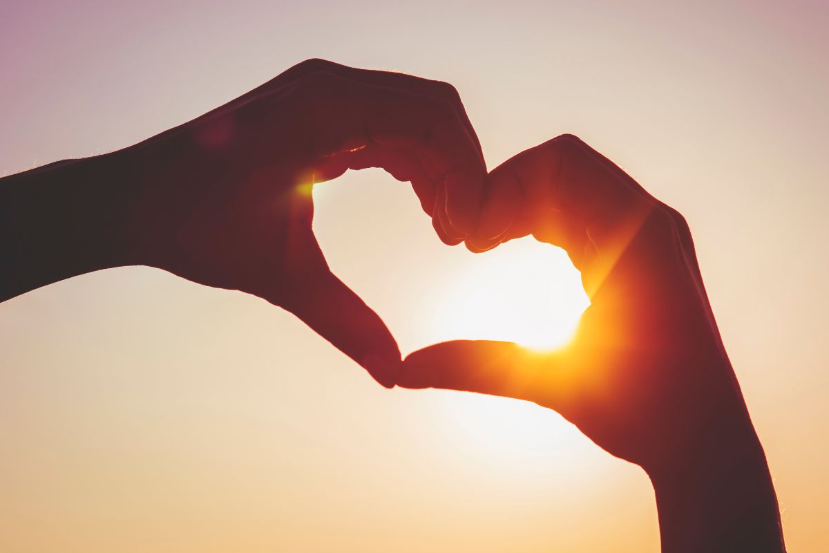 Image of a hand forming a heart shape.