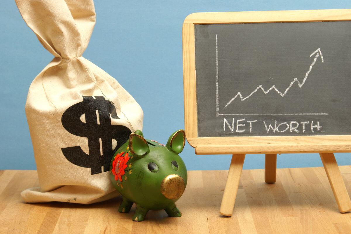 The image shows a sock with a dollar sign, a piggy bank, and a blackboard with notes and a graph referring to a positive net worth in your 20s as the best time to build wealth habits that will grow into a solid foundation for retirement.