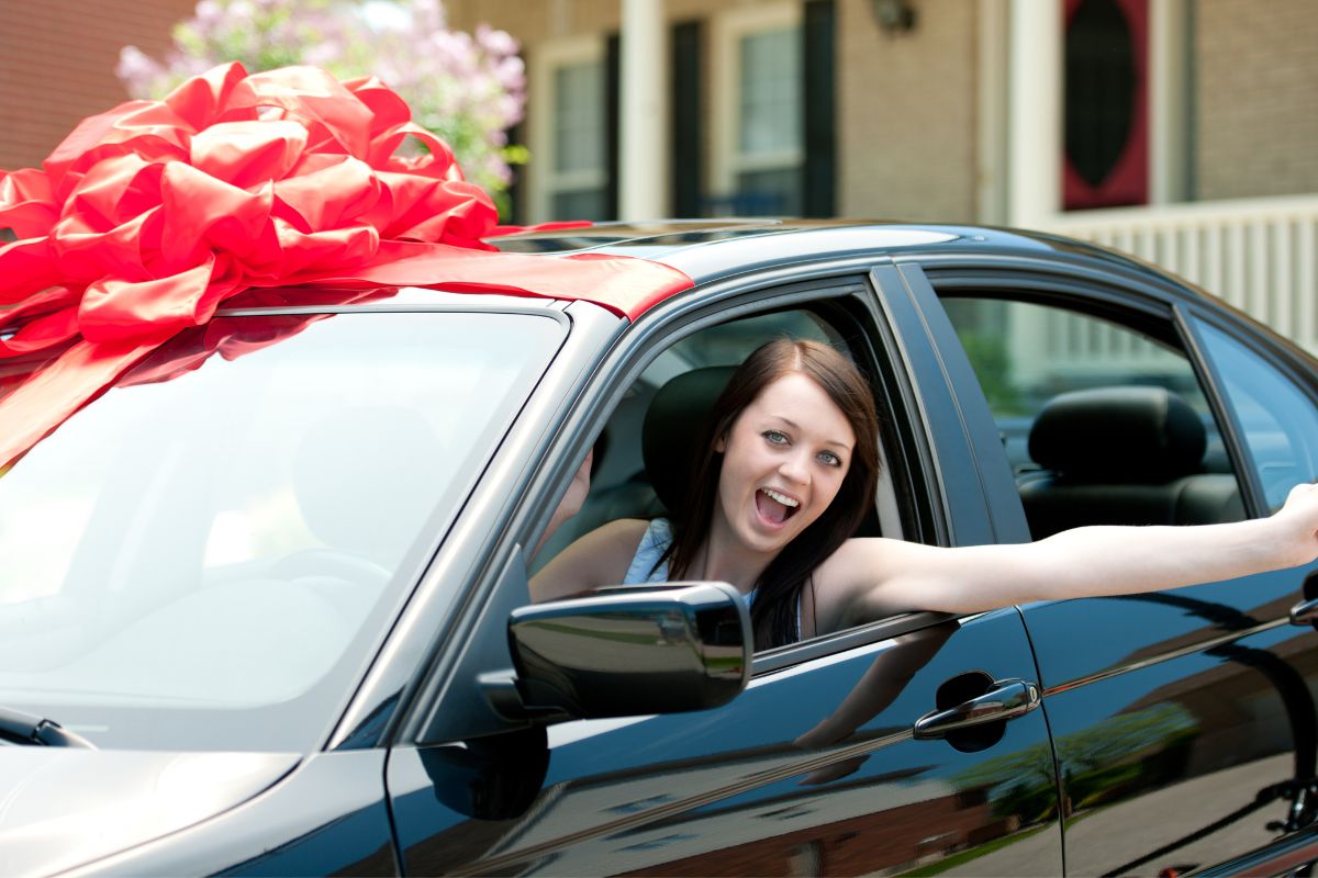Photo of a woman with new cars.