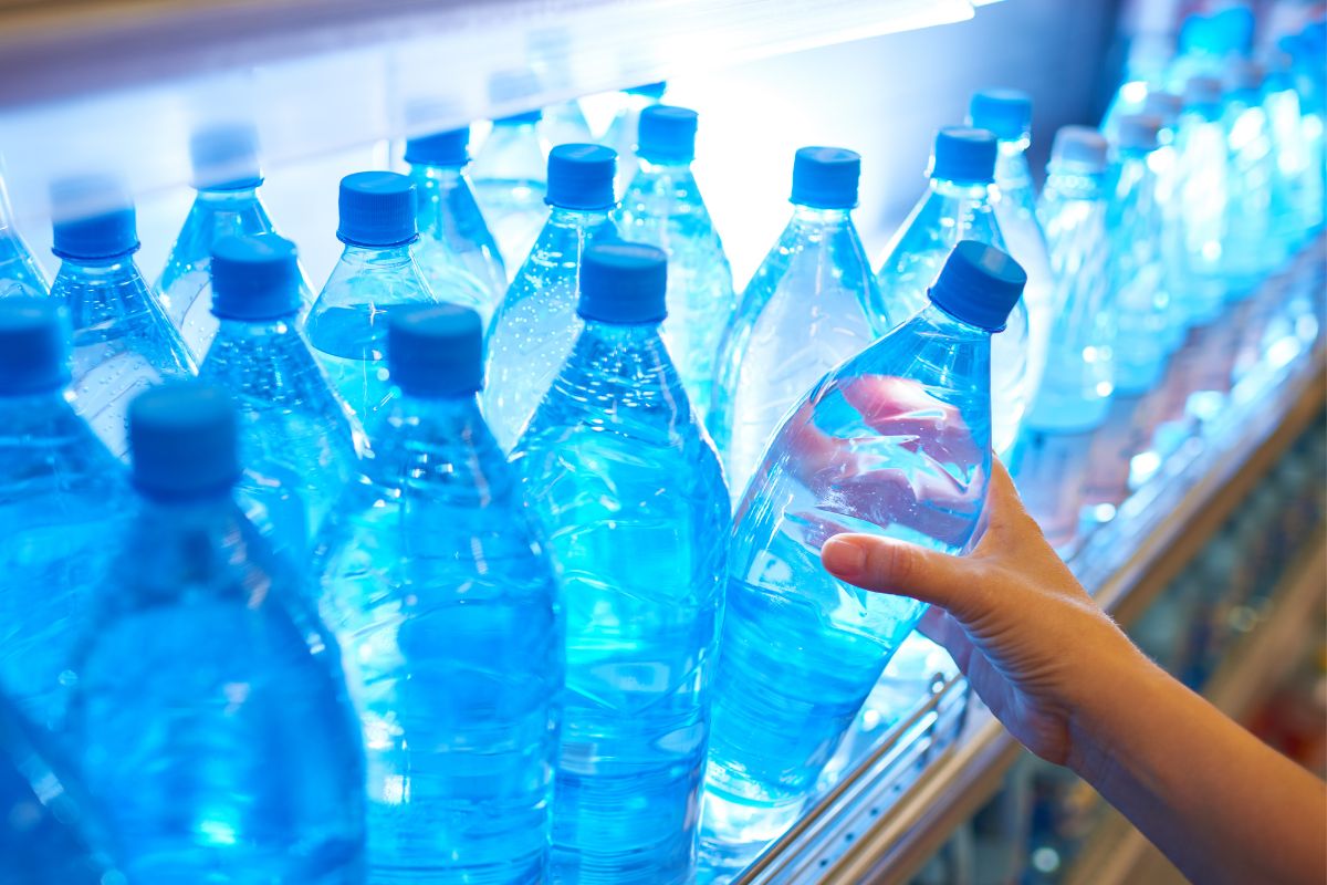 The picture of a woman picking bottled water.