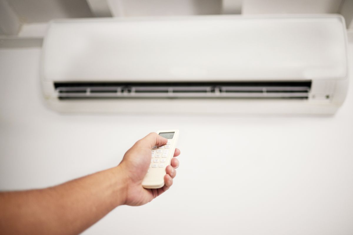 Image of a man's hand adjusting the cooling temperature.