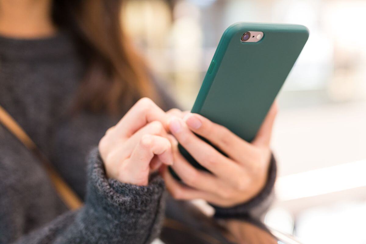 Image of a woman using a phone.