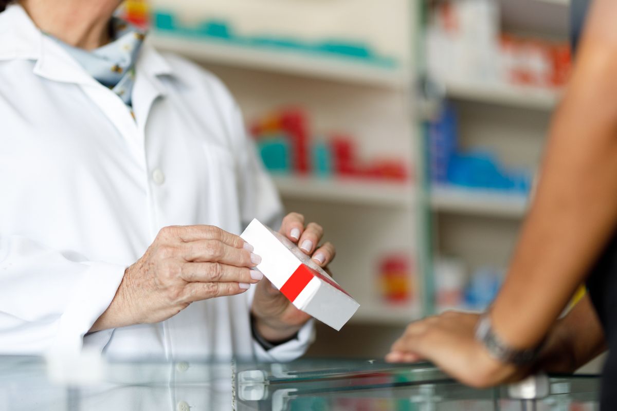 The image shows a man buying  name-brand medications.