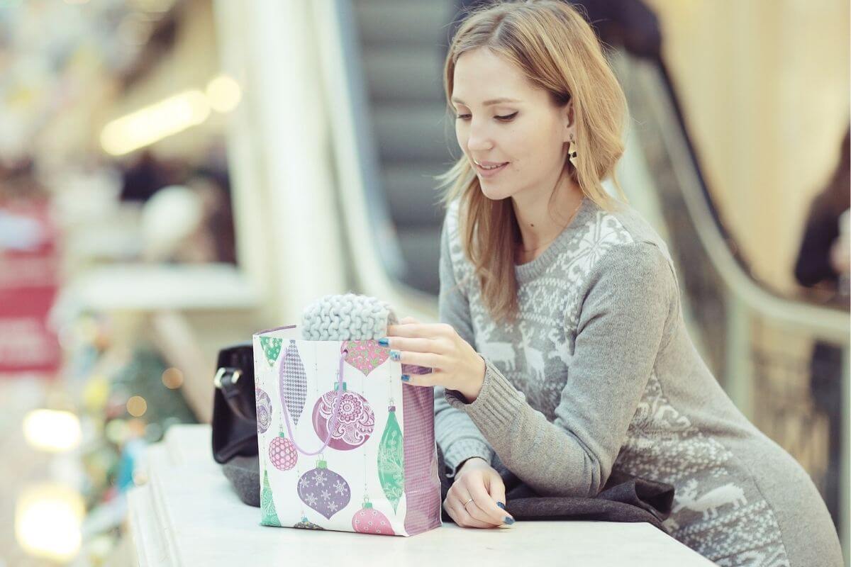 Photo of a woman buying a gift.