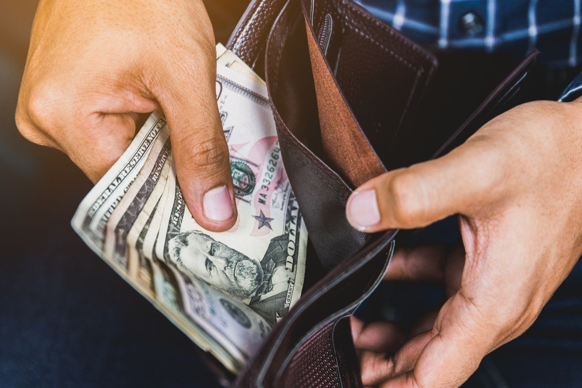 The picture shows a man not spending money.