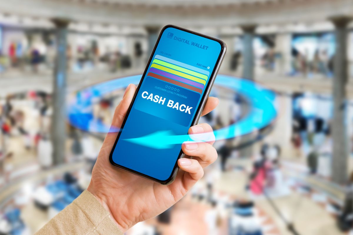 The image shows a woman's hand using a cash-back app.