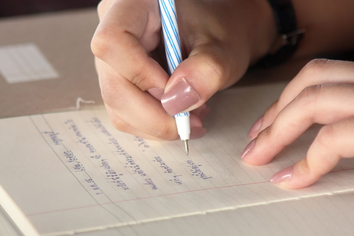A woman's hand and writing a letter.
