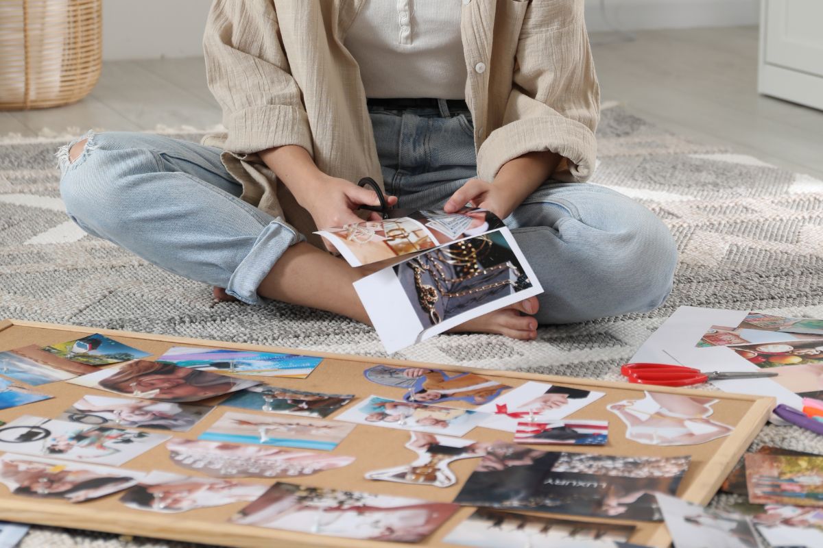 Image of a woman visualizing a debt-free future with a vision board.