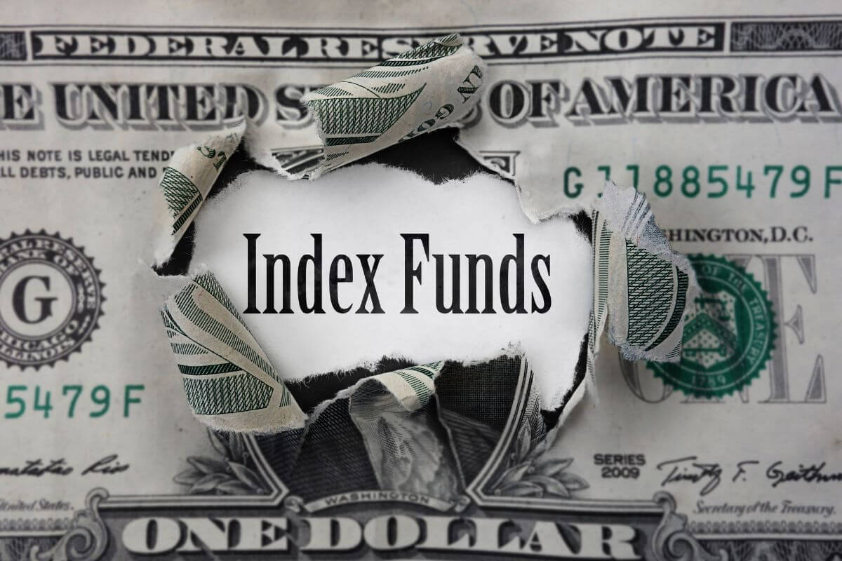 The image shows a torn dollar bill with notes in between which refers to investing in index funds for easy and long-term growth making them freat for retirement savings.