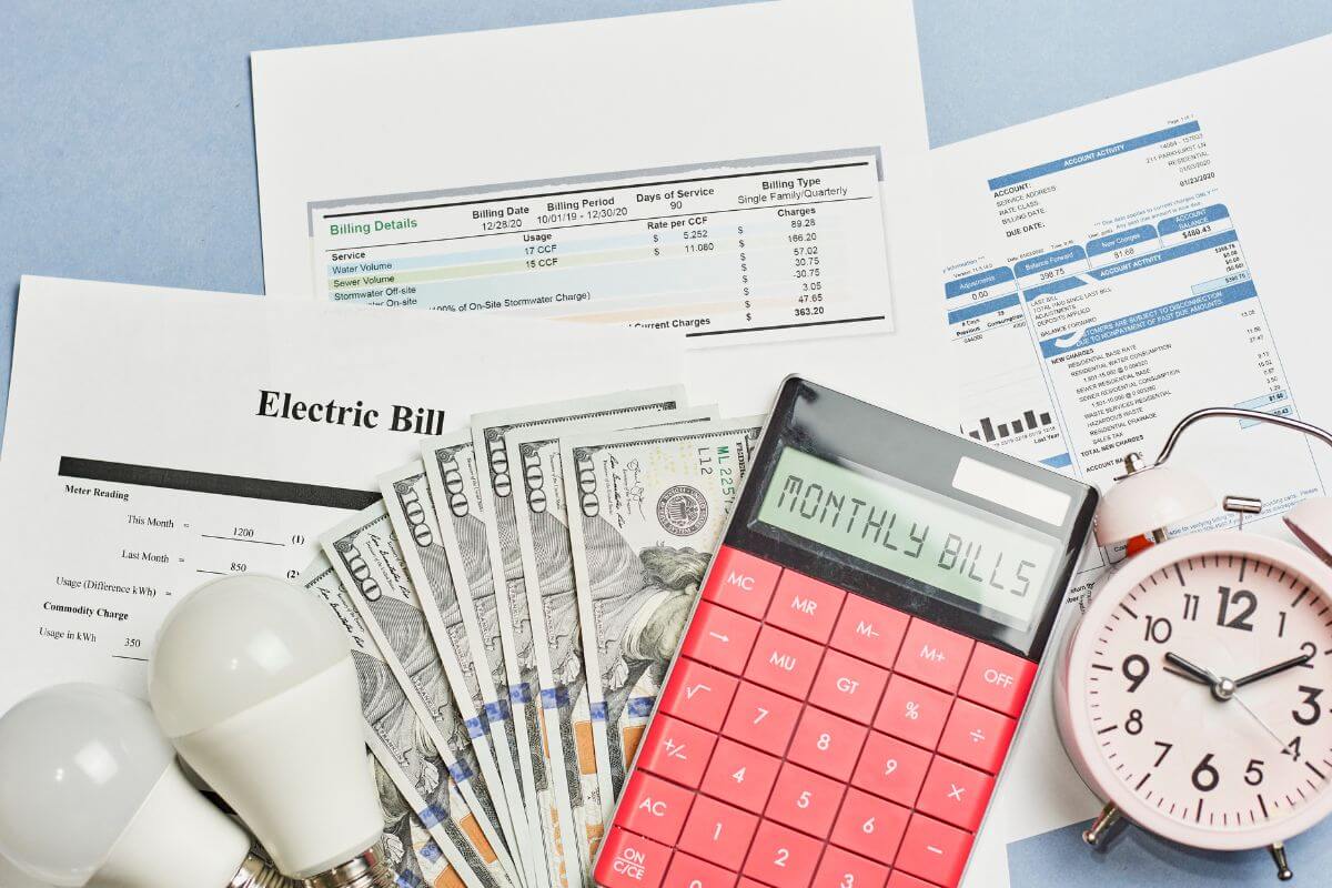 The image tells about a clock, bulbs, a calculator, dollar bills, and papers with notes referring to negotiating bills that could lower your monthly cost and put more cash in your pocket without changing your lifestyle.