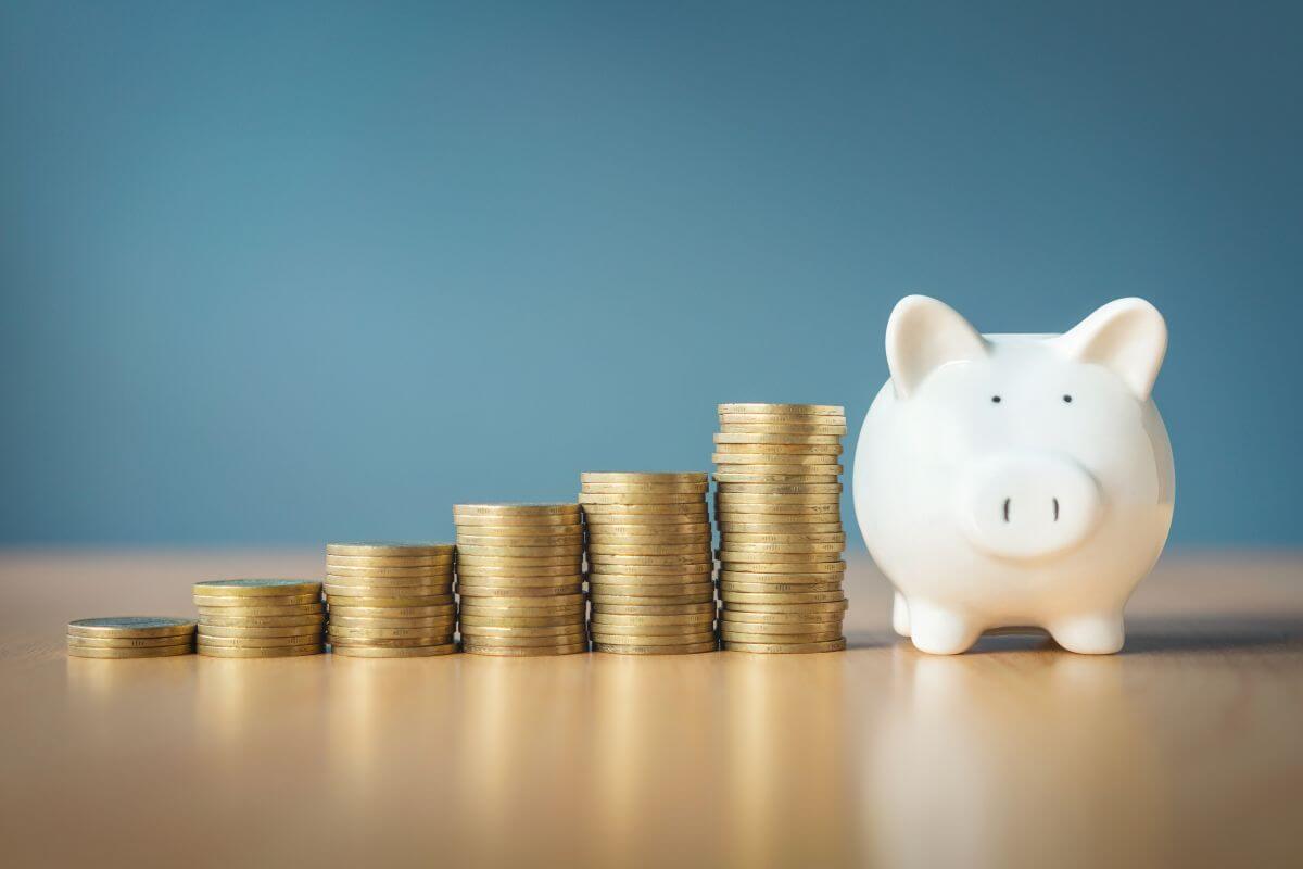 The picture of stock coins and a piggy bank indicates that your savings journey starts now which can lead to big results over time.