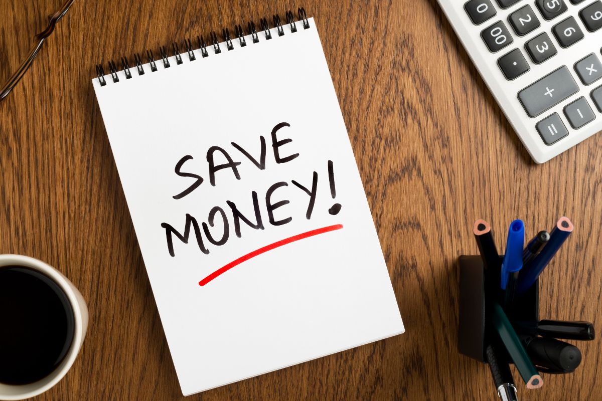 Image of a notebook with save money wording.