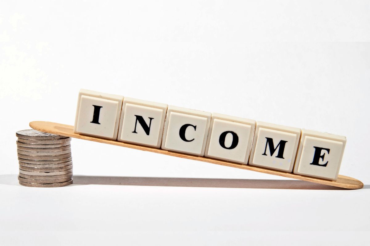 The picture shows a coin stock and cubes with letters indicating to reduce reliance on a single income source to avoid financial failures.