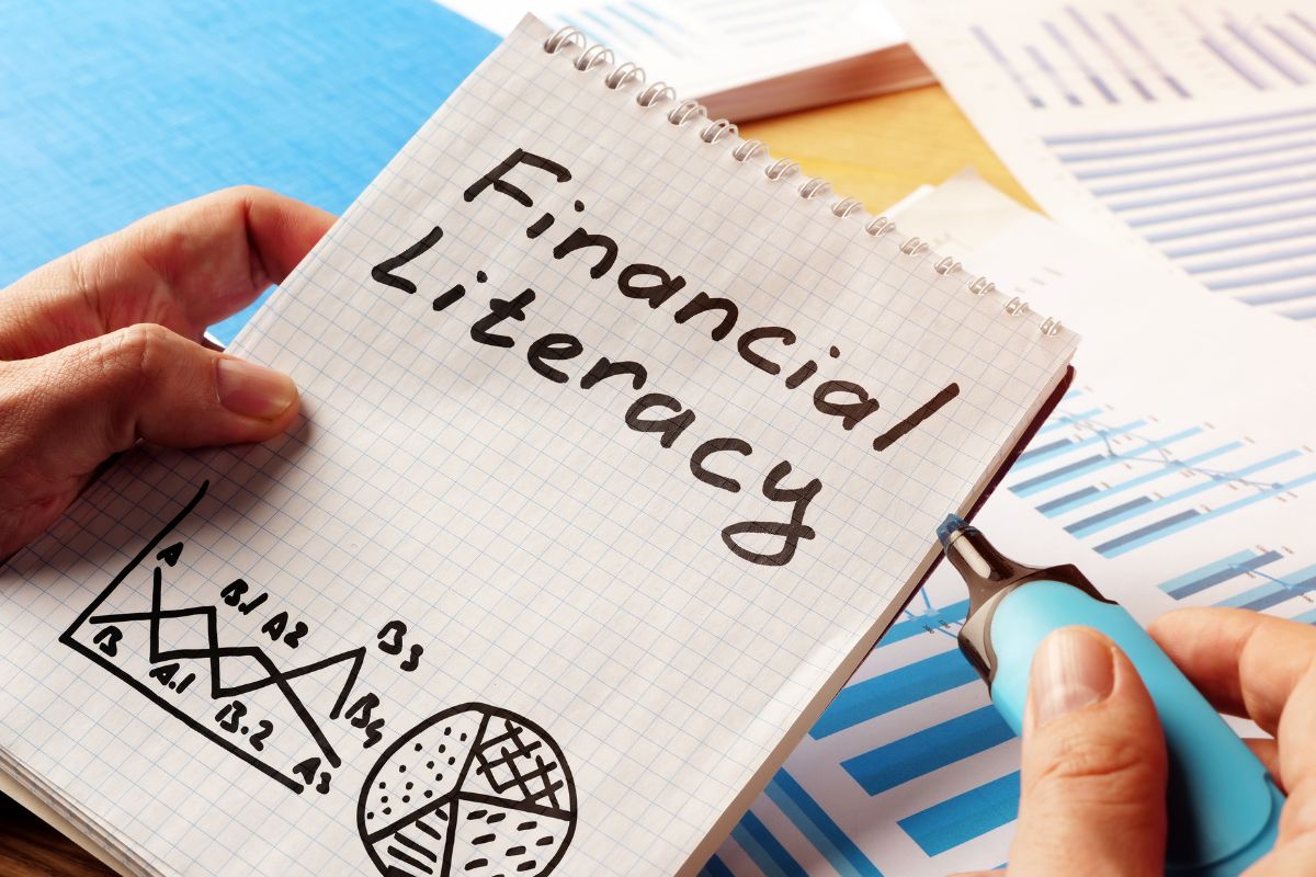 Image of a woman's hand and a financial literacy wording.