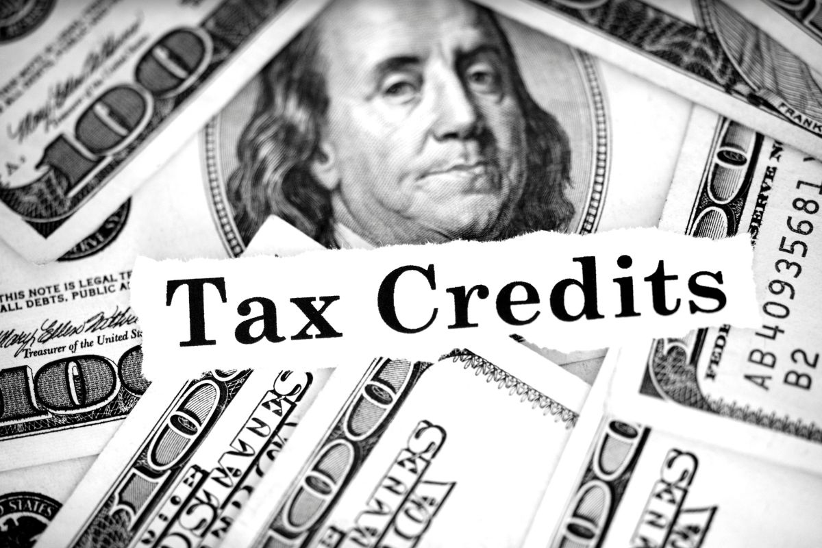 Picture of dollar bills and tax credits wording. 