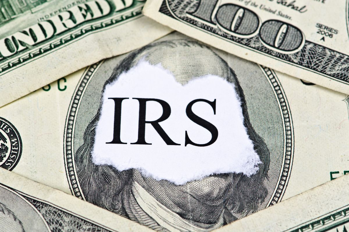 The photo tells about dollar bills and a piece of paper with a note which means using free tax filing services like the IRS offers free tax help for eligible students.