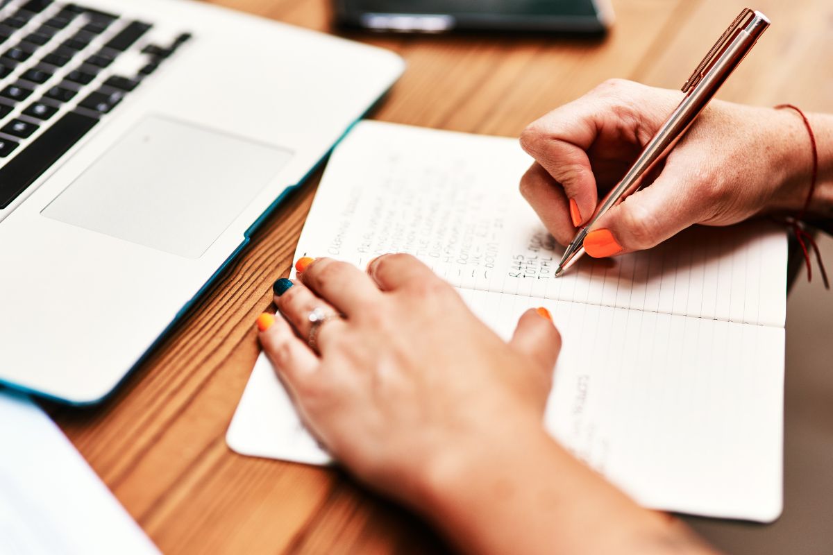 An image of a woman's hand tracking her deductible expenses.
