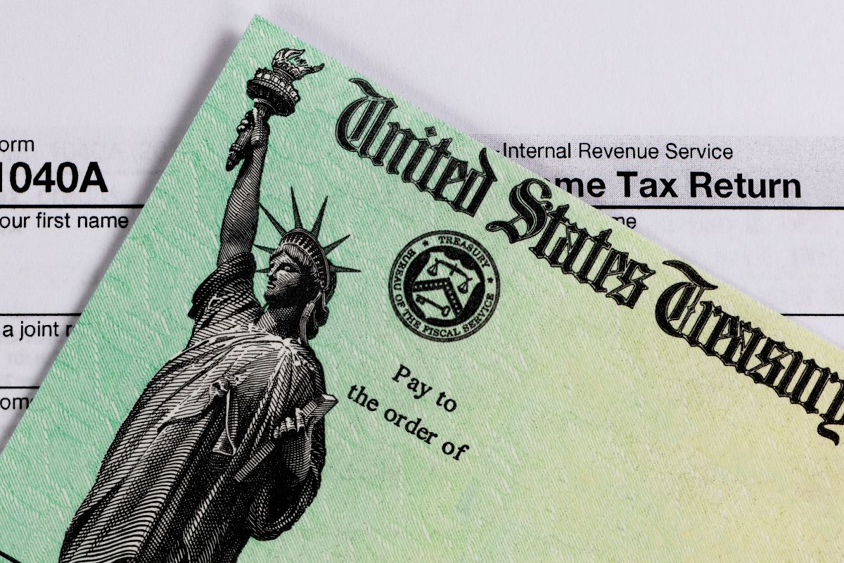 The image shows a piece of paper with notes and a paper with liberty icon and notes which means that considering state taxes if you attend college in a different state can help you prepare and avoid last-minute surprises.