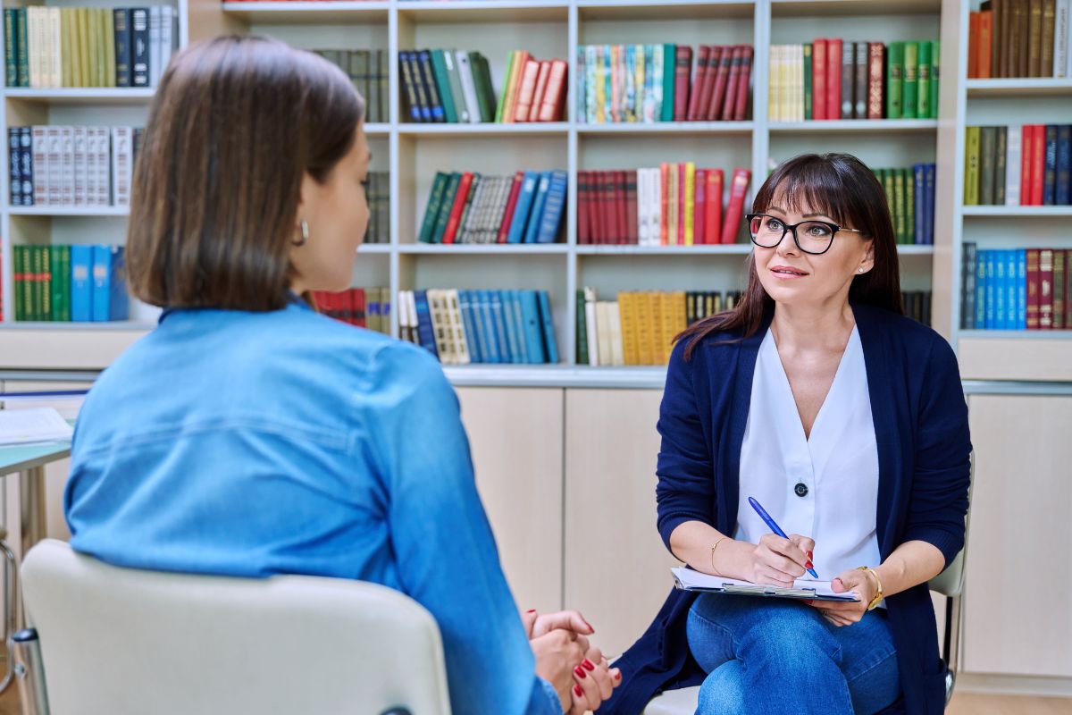 The photo shows books and a girl talking to the professional girl and taking notes which means asking for help if needed to ensure you file correctly and don't miss out on savings.