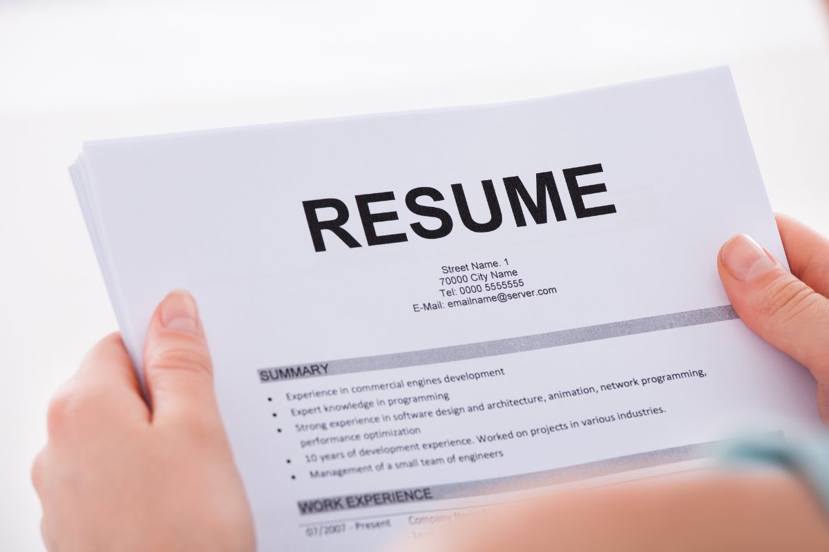 The image shows a woman and her resume.