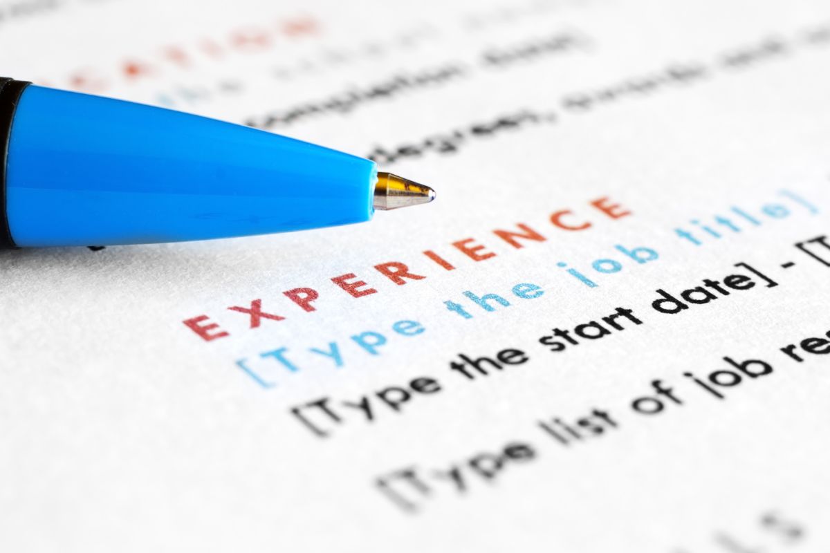 Photo of a pen and experience content in a resume.